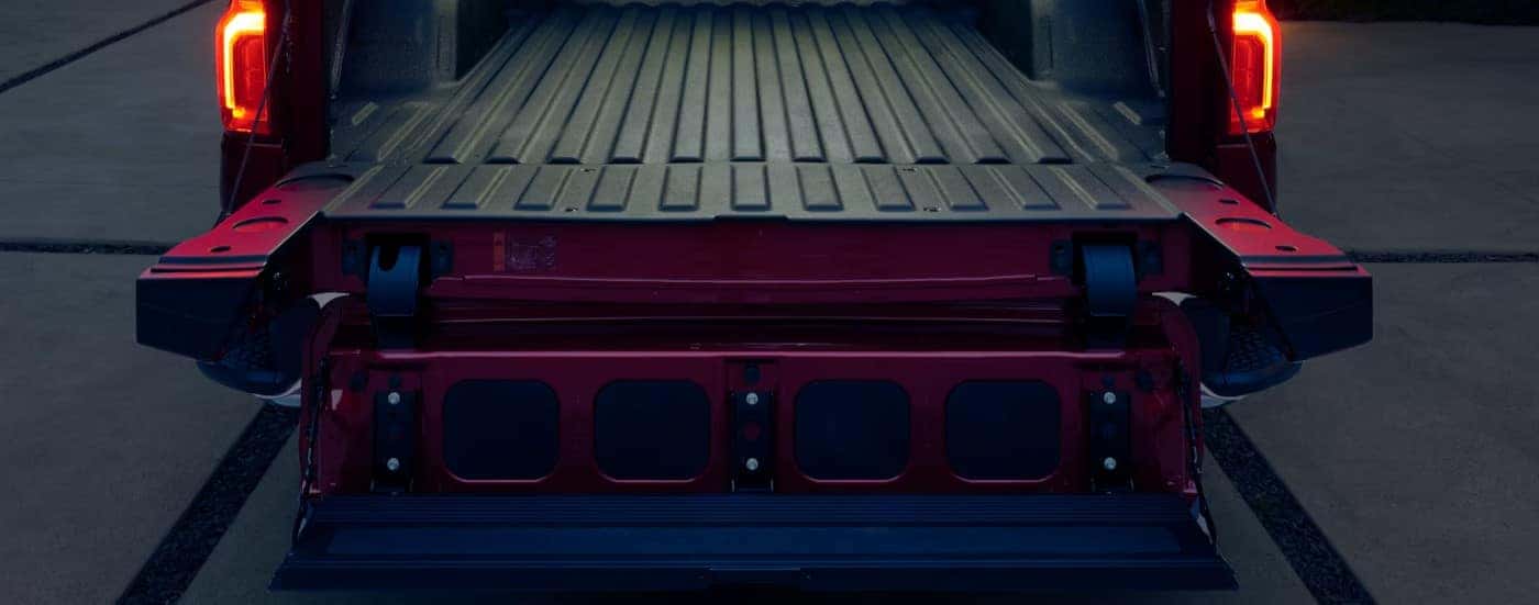 A close-up of the multiflex tailgate is shown on a red 2025 Chevy Silverado 1500.