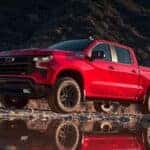 A red 2025 Chevy Silverado 1500 Z71 Trail Boss is shown from the side.