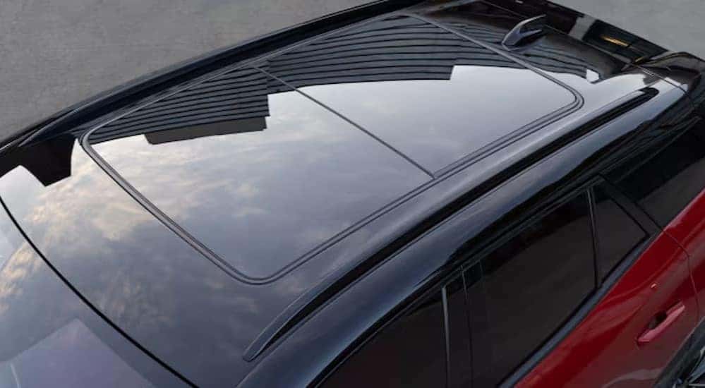 A close-up of the sunroof is shown in a red 2025 Chevy Blazer EV RS.