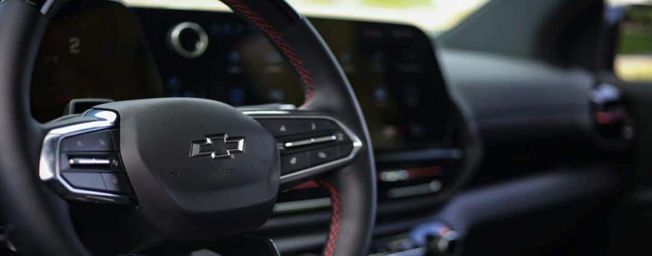 A close-up of the steering wheel is shown in a 2025 Chevy Silverado EV.
