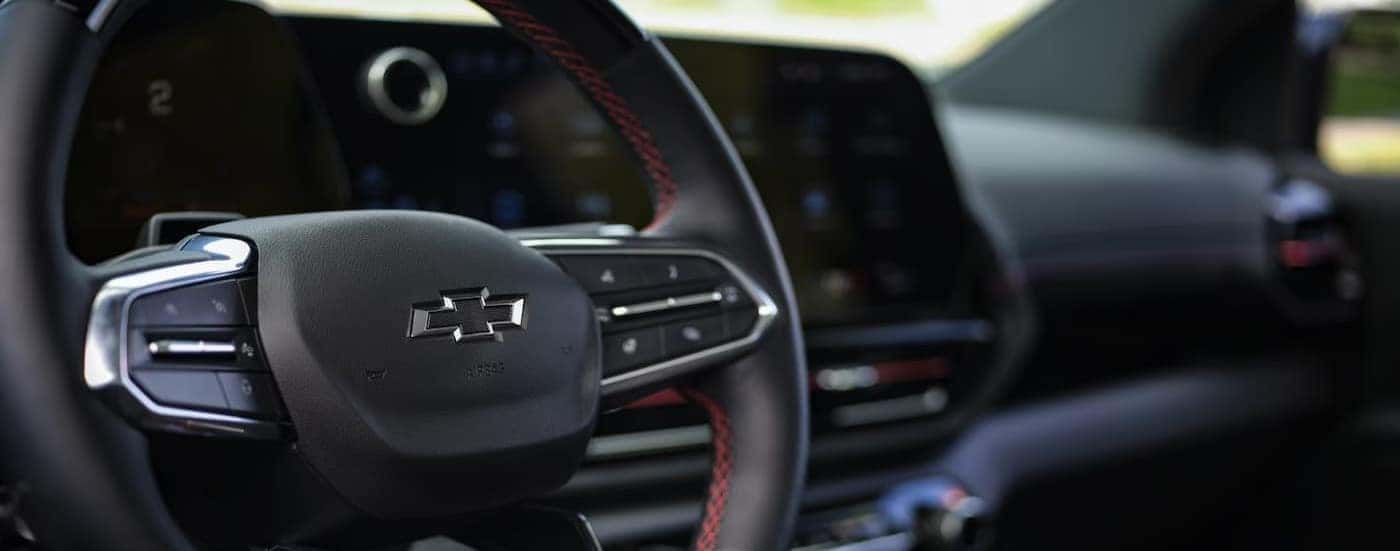 A close-up of the steering wheel is shown in a 2025 Chevy Silverado EV.
