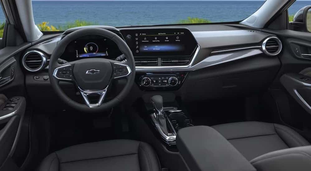 The black interior and dash are shown in a 2025 Chevy Trax for sale.