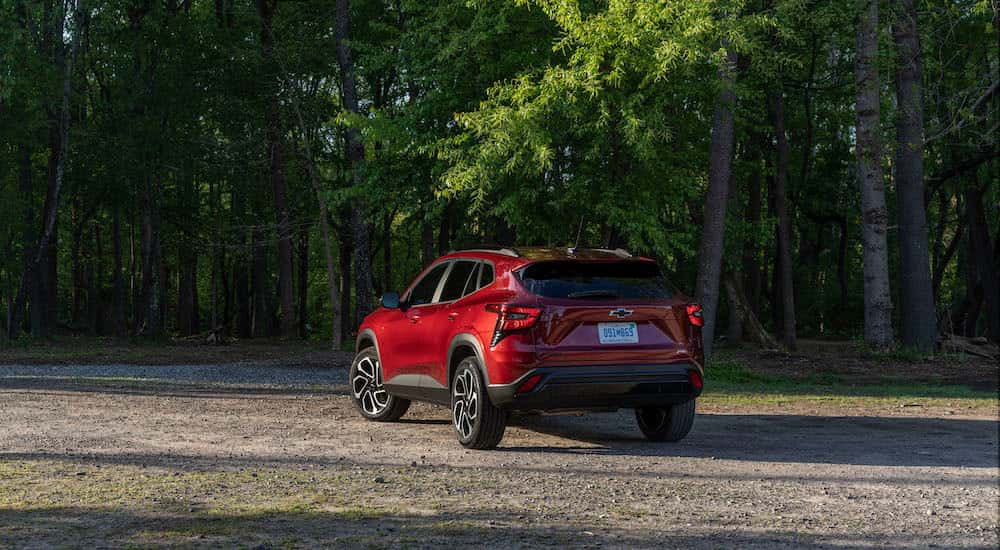 A red 2025 Chevy Trax RS is shown from the rear at an angle.