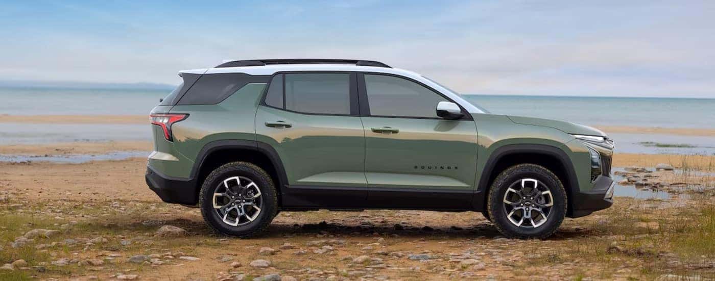 A green 2025 Chevy Equinox ACTIV is shown parked near water.