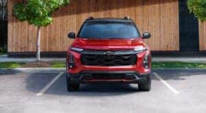 A red 2025 Chevy Equinox RS is shown parked on a parking spot.