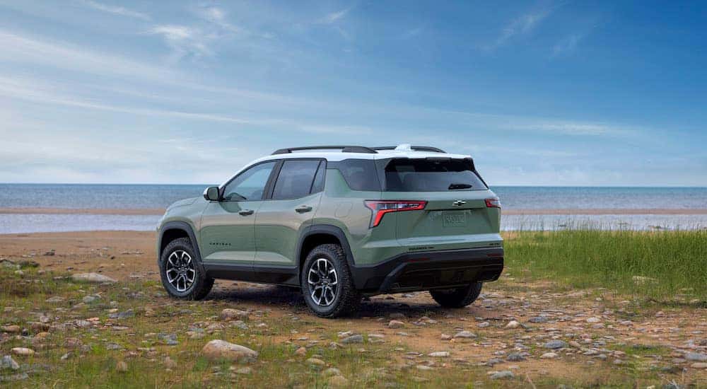 A green 2024 Chevy Equinox ACTIV is shown from the rear at an angle.