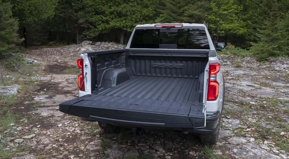 Rear of a white 2025 Chevy Silverado 1500 ZR2 with an open tailgate.