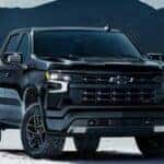 Black 2025 Chevy Silverado 1500 for sale in Atlanta parked on sand.
