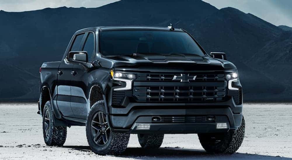 Black 2025 Chevy Silverado 1500 for sale in Atlanta parked on sand.