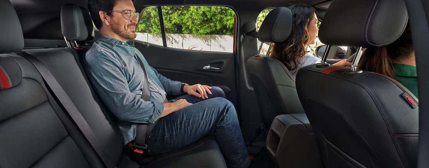 Man sitting in the backseat of a 2025 Chevy Trax.