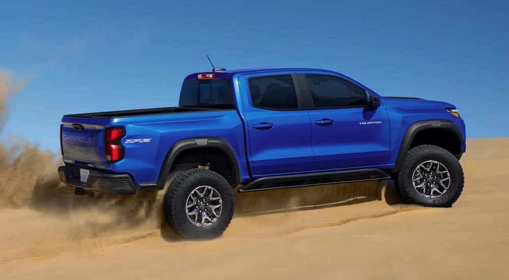 Blue 2025 Chevy Colorado ZR2 driving through a desert.