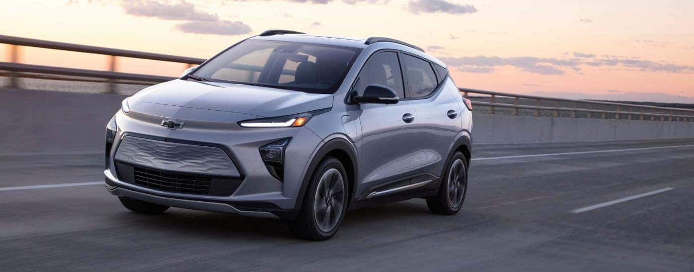 Silver 2022 Chevy Bolt EUV driving from a Chevy dealer near Alpharetta.