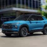 A blue 2025 Chevy Trailblazer RS driving on a city street.