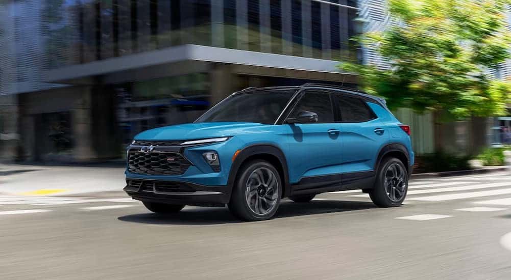 A blue 2025 Chevy Trailblazer RS driving on a city street.