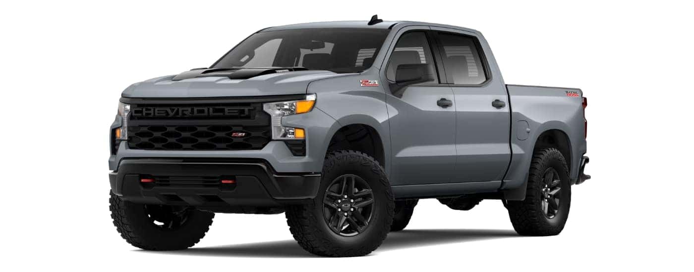 A grey 2025 Chevy Silverado 1500 Custom Trail Boss angled left.