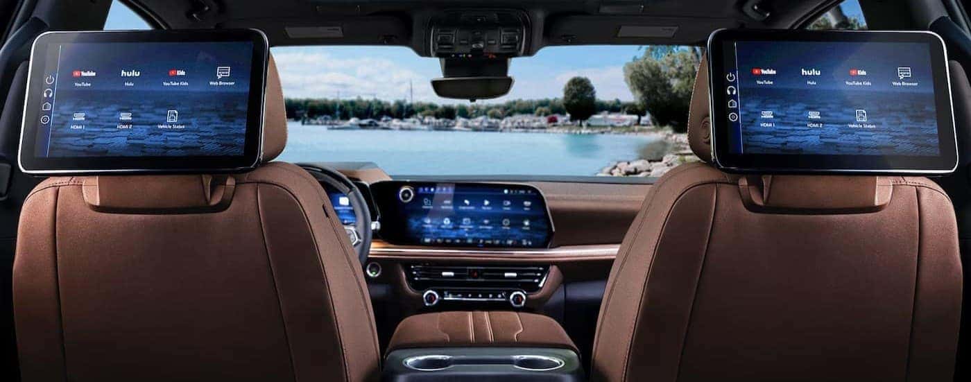 The brown interior and infotainment screens in a 2025 Chevy Suburban.
