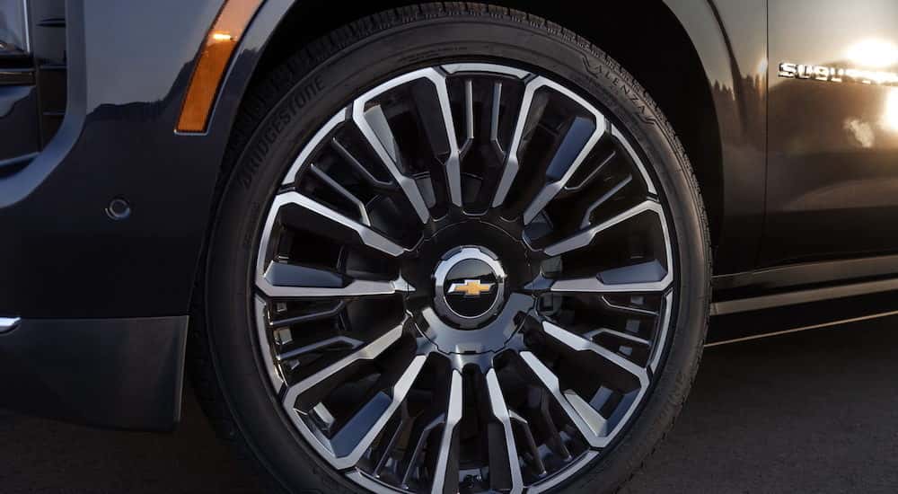 The wheel of a black 2025 Chevy Suburban.