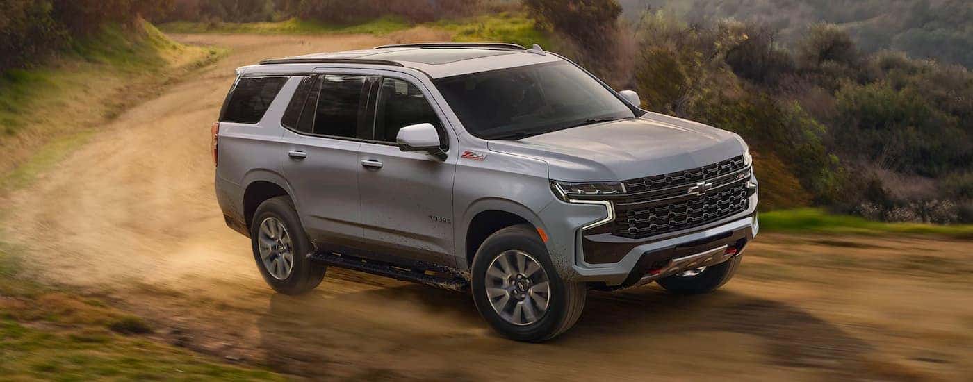 Grey 2024 Chevy Tahoe Z71 driving down a trail.