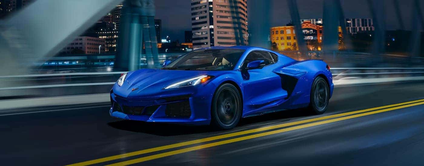 Blue 2025 Chevy Corvette E-Ray driving on a highway