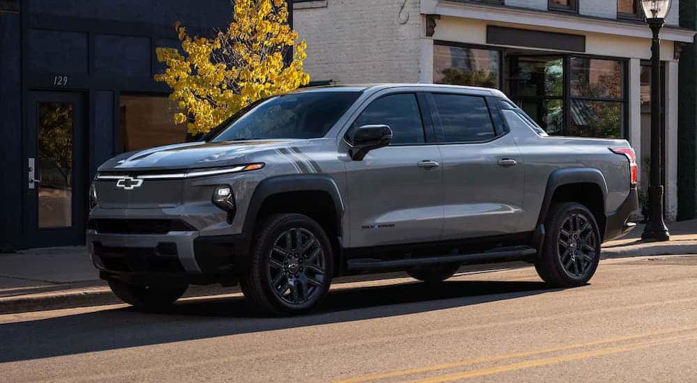 A gray 2025 Chevy Silverado EV for sale parked in a city