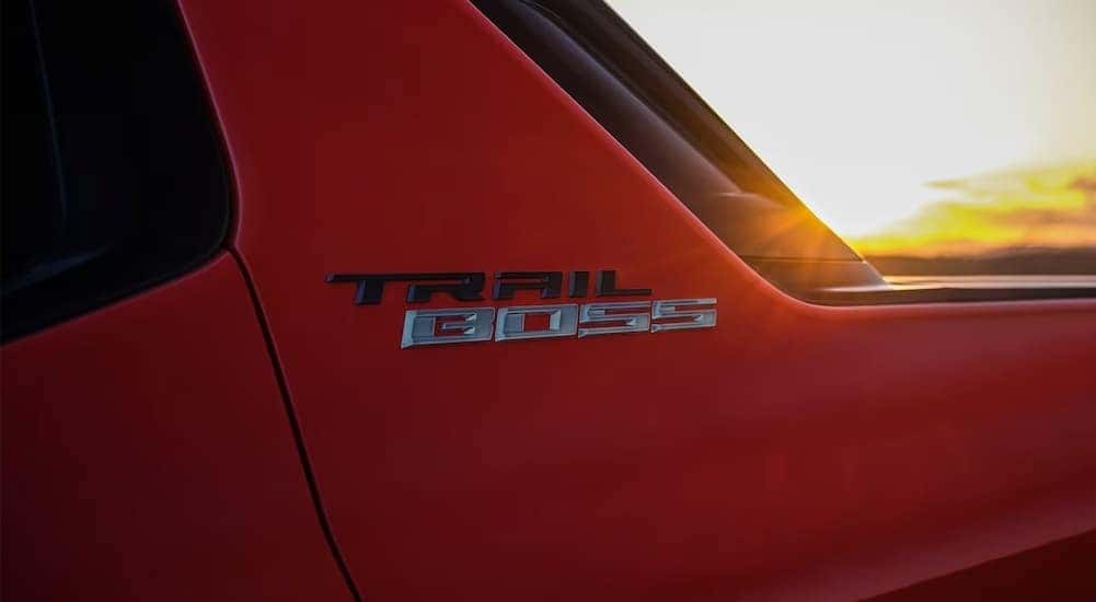 Close-up of the logo on a red 2025 Chevy Silverado EV Trail Boss.