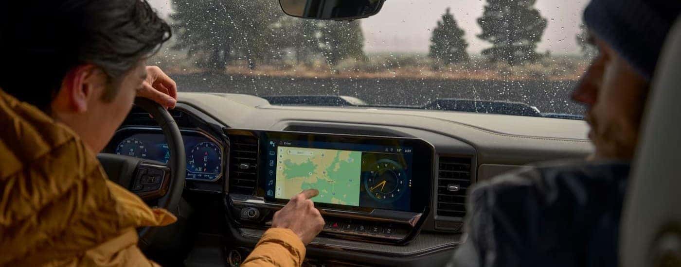 A person using the infotainment screen in a 2026 Chevy Silverado 1500.