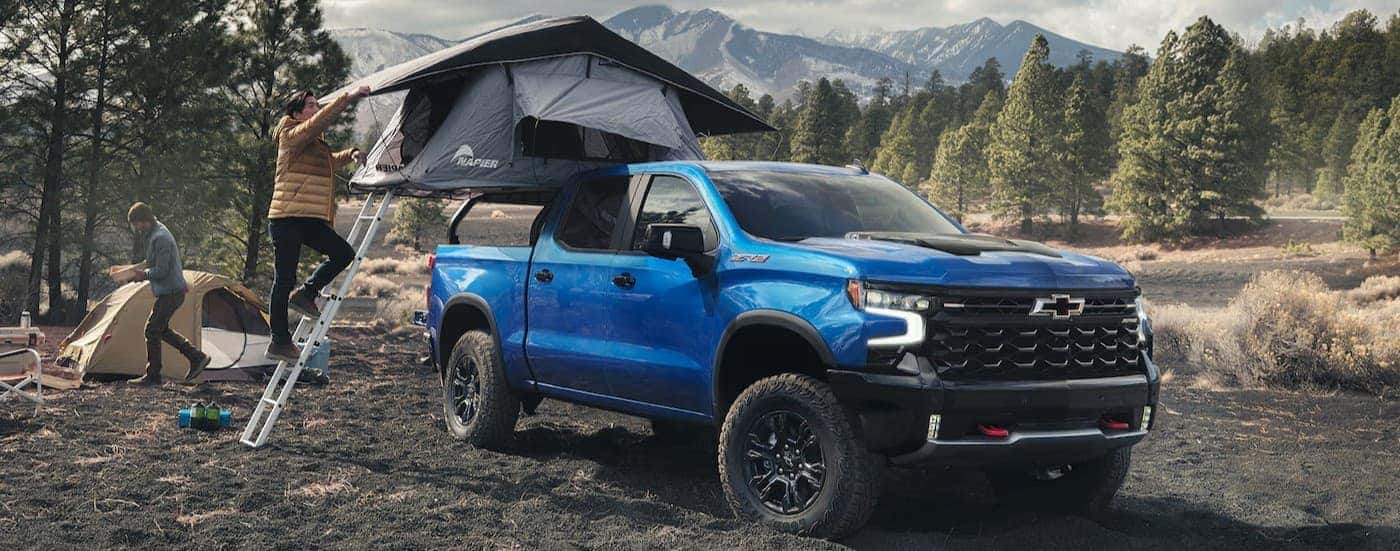 A blue 2026 Chevy Silverado 1500 ZR2 parked on a campsite.