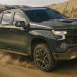 A green 2026 Chevy Silverado 1500 Z71 off-roading.