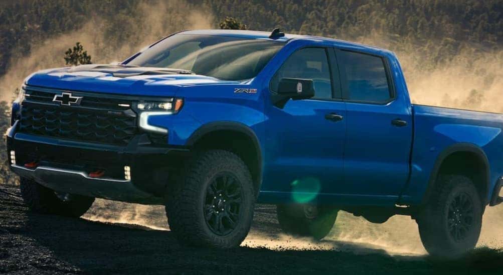 A blue 2026 Chevy Silverado 1500 ZR2 parked off-road.