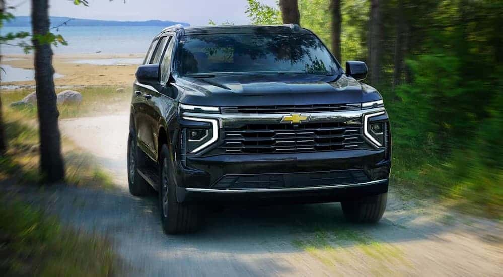 A blue 2025 Chevy Tahoe driving off-road.