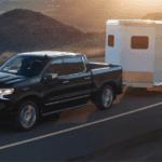 Black 2026 Chevy Silverado 1500 High Country LD towing a trailer