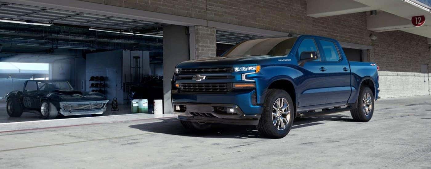 Blue 2019 Chevy Silverado 1500 for sale near Duluth parked in front of a garage