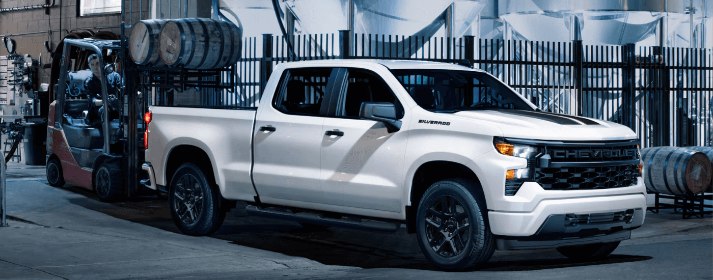 White 2025 Chevy Silverado 1500 Rally with the bed being loaded