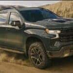 A green 2026 Chevy Silverado 1500 Z71 off-roading.