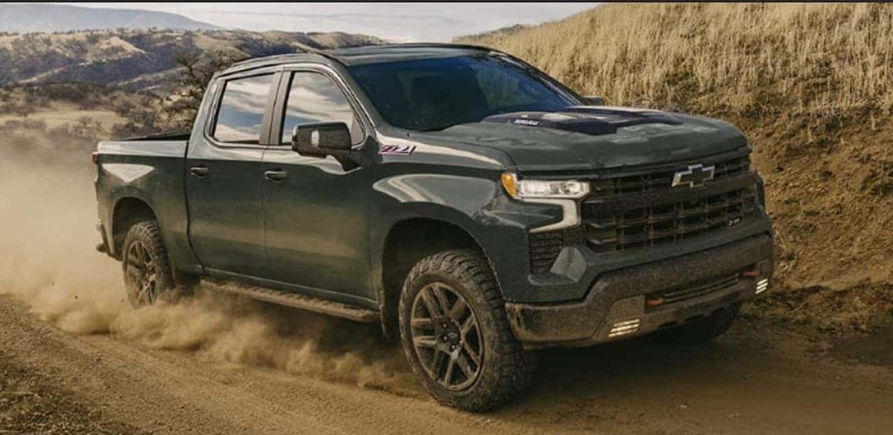 A green 2026 Chevy Silverado 1500 Z71 off-roading.
