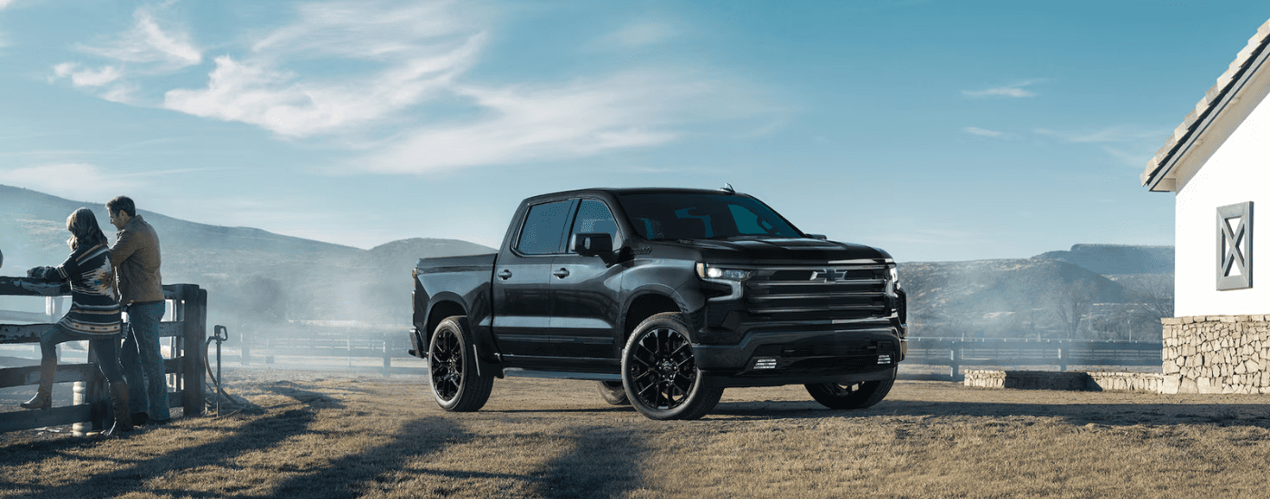 Black 2026 Chevy Silverado 1500 High Country parked on a farm