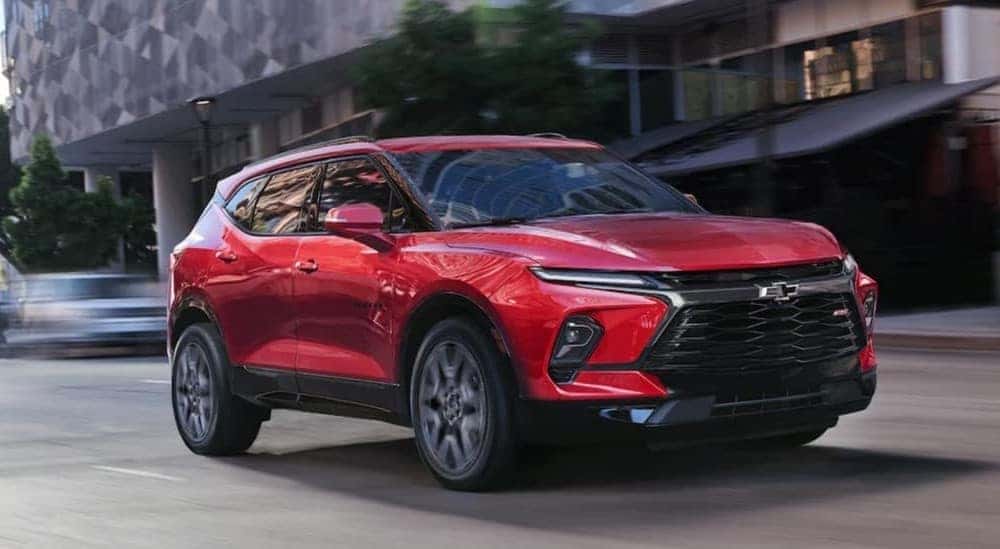 A red 2026 Chevy Blazer driving in a city.