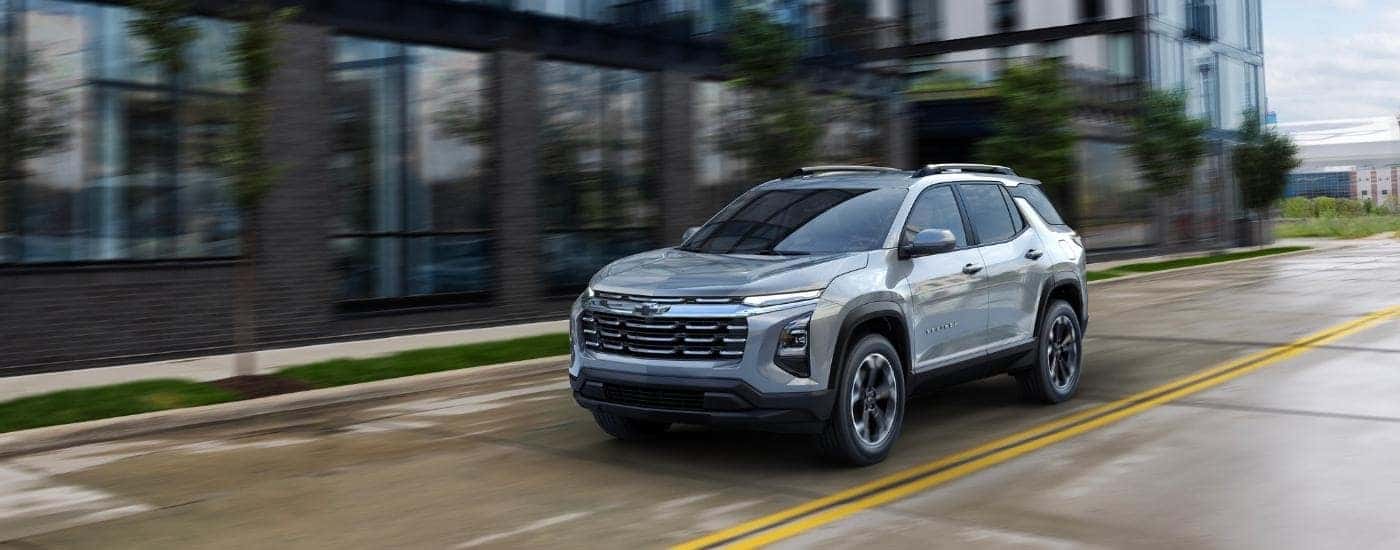 Grey 2026 Chevy Equinox driving on a rainy day