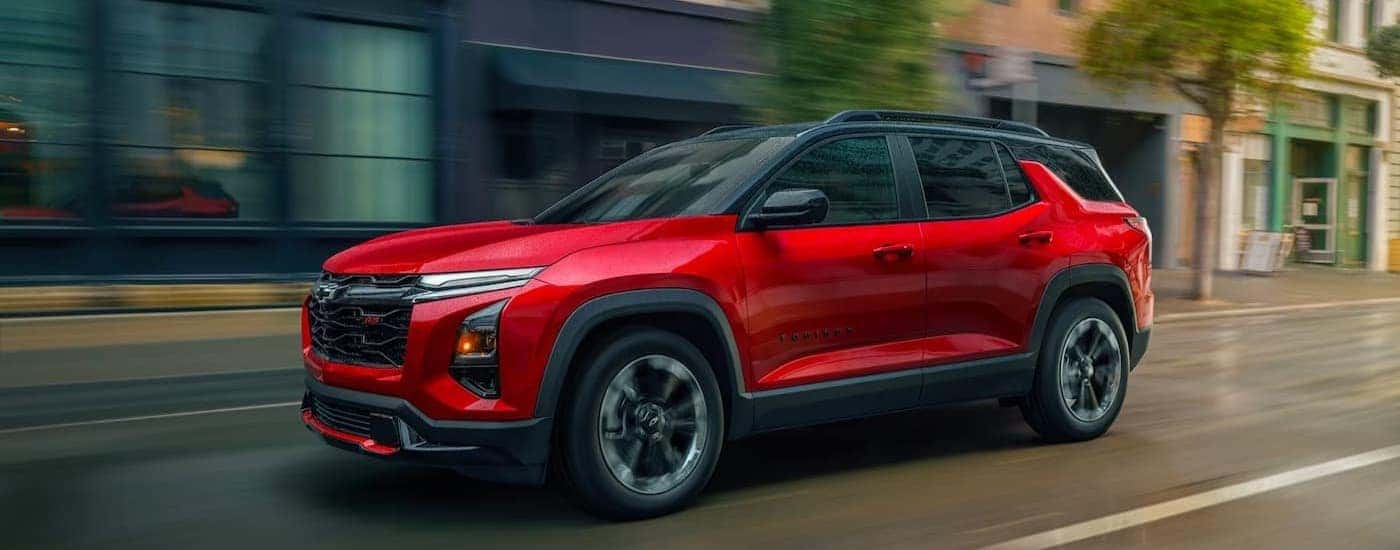 A red2026 Chevy Equinox RS driving in a city.