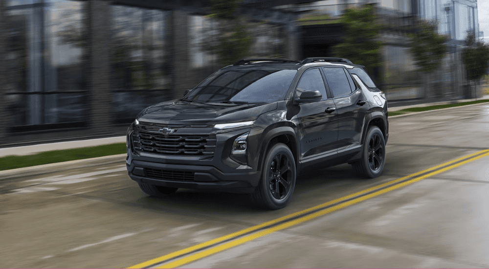 Black 2026 Chevy Equinox driving through a city