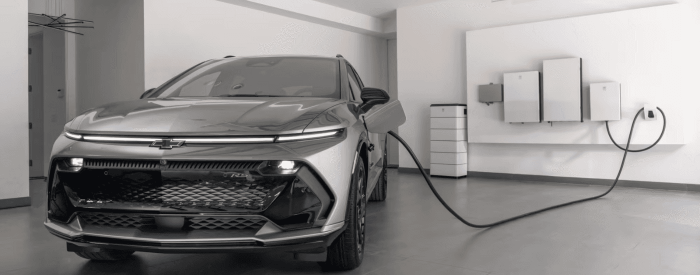 Silver 2026 Chevy Equinox EV charging in a garage