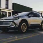 Silver 2026 Chevy Equinox EV driving down a street