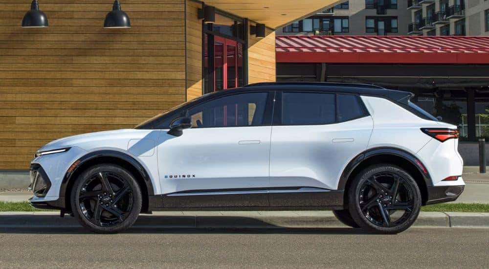 White 2026 Chevy Equinox parked on the street outside shops