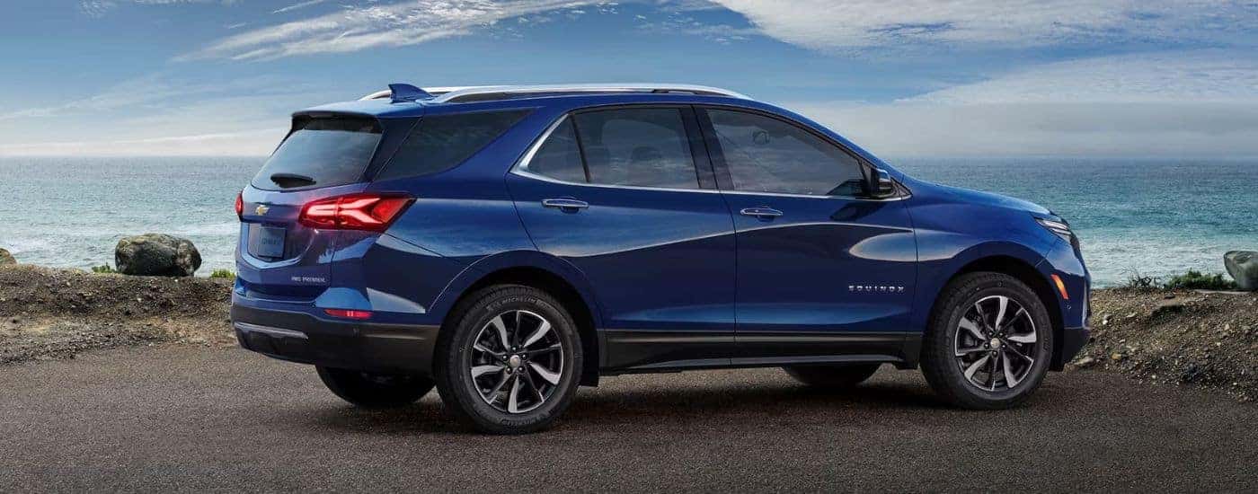 A dark blue 2023 Chevy Equinox parked on the beach.