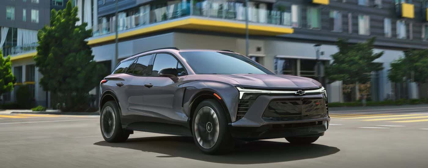 A gray 2026 Chevy Blazer EV driving in a city.