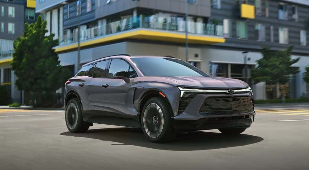 A grey Chevy Blazer EV RS shown driving in a city.