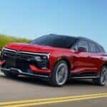 A red 2026 Chevy Blazer EV SS shown driving a shoreline.