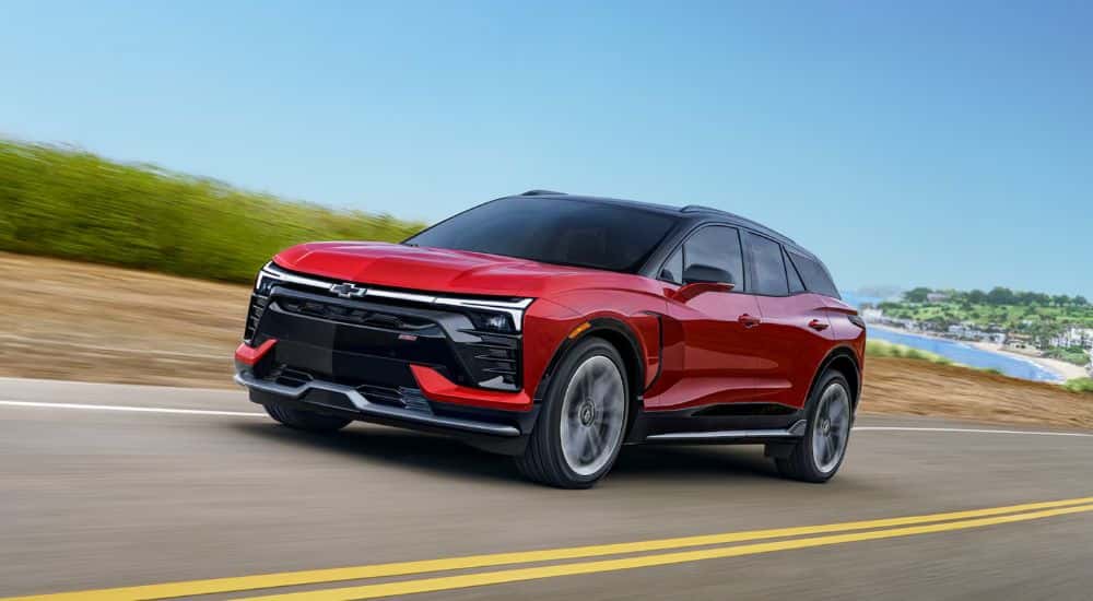 A red 2026 Chevy Blazer EV SS shown driving a shoreline.