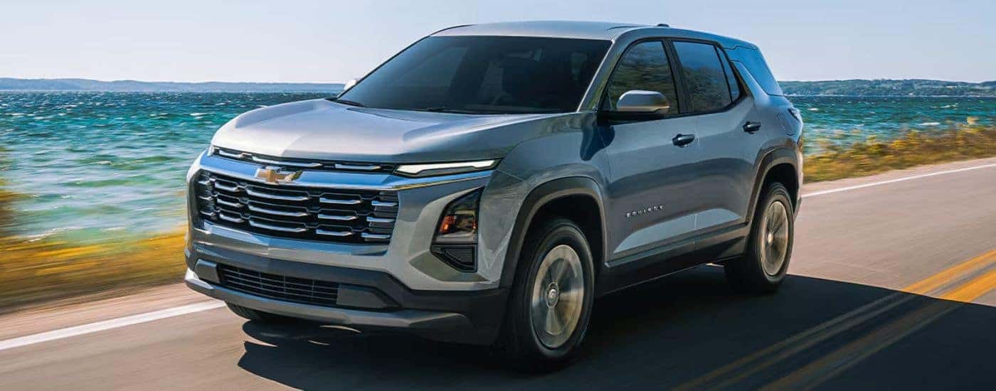 A silver 2026 Chevy Equinox driving by the ocean.
