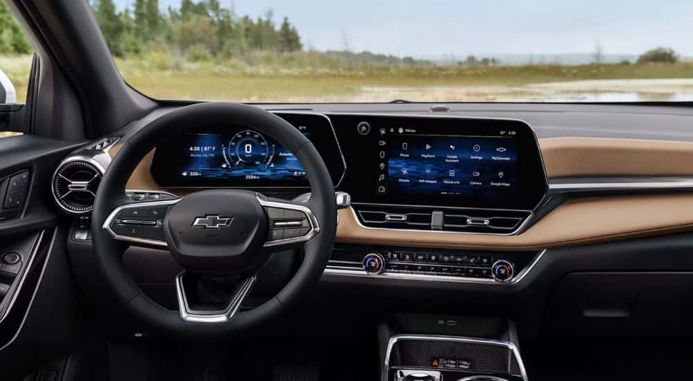 Interior view of a 2026 Chevy Equinox infotainment display and steering wheel.